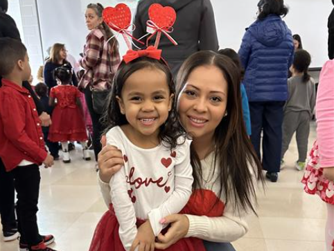 Students pose with parents at Valentine's Day dance