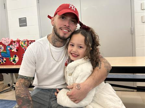 Students pose with parents at Valentine's Day dance