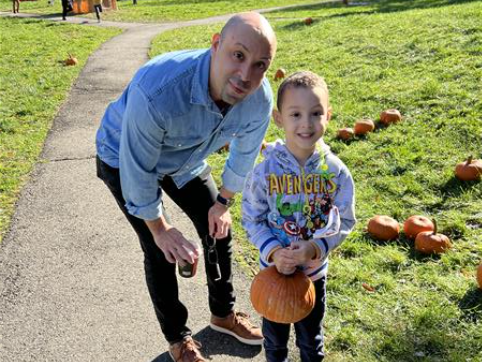 Students pose with pumpkins and their parents