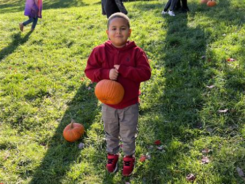 Students pose with pumpkins and their parents