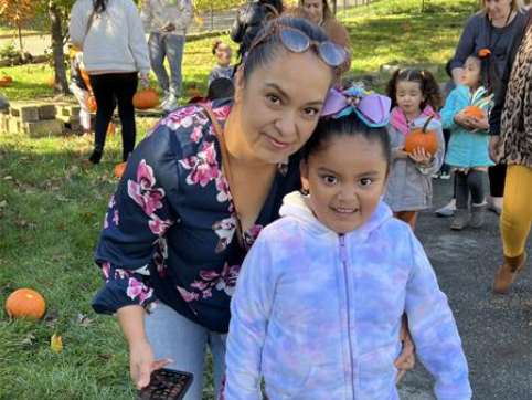 Students pose with pumpkins and their parents