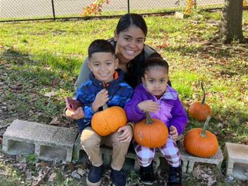 Students pose with pumpkins and their parents