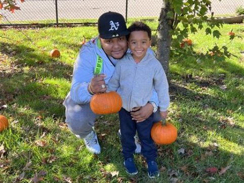 Students pose with pumpkins and their parents