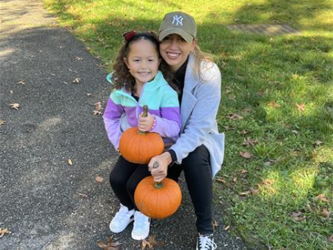 Students pose with pumpkins and their parents